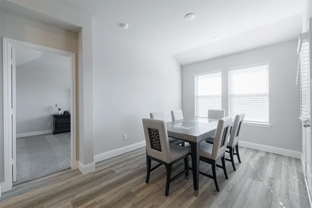 a view of a dining room with furniture and wooden floor