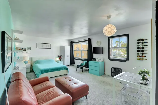 a living room with furniture wooden floor and a flat screen tv