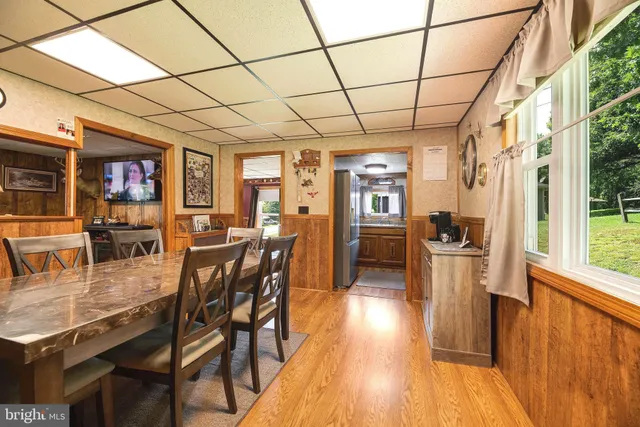 a kitchen with granite countertop stainless steel appliances a sink stove and cabinets