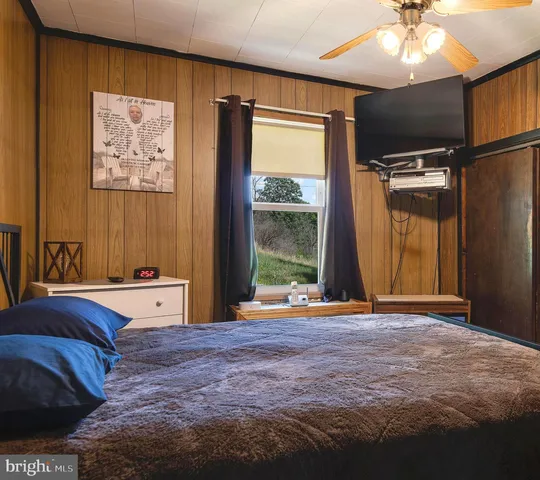 a bedroom with a bed and a window