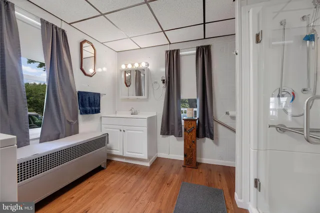 a bathroom with a granite countertop sink toilet and shower
