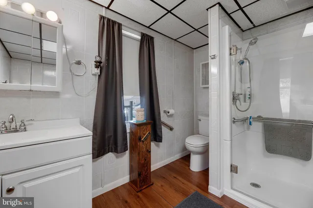 a living room with furniture a large window and chandelier