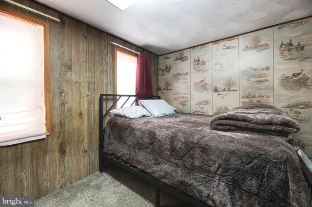 a bedroom with a bed and a large mirror