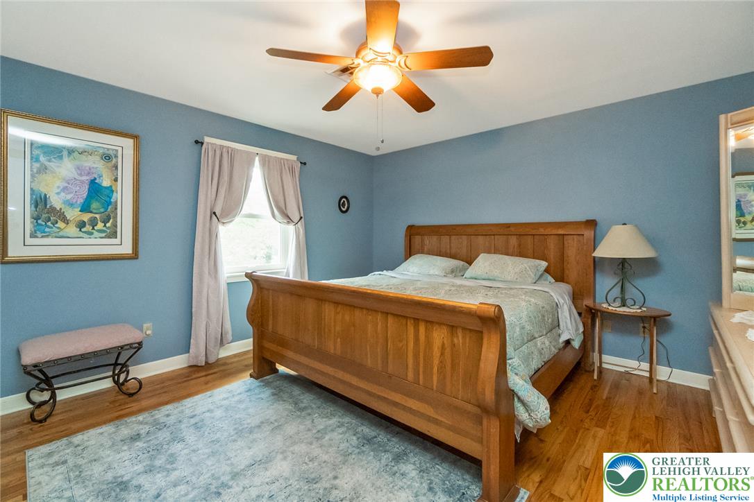 1553 Surrey Road Bethlehem, PA 18015 - Photo 44 of 92 Hardwood floors and a well-lit window create a serene atmosphere in this bedroom.