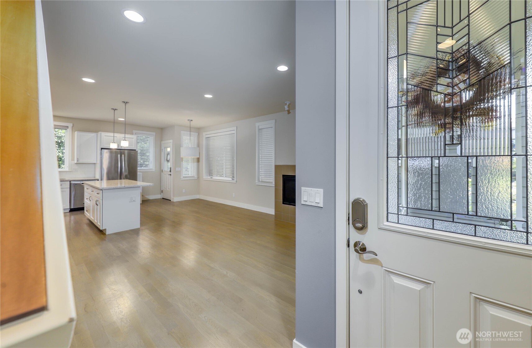 690 Wintersweet Road Northeast Bainbridge Island, WA 98110 - Photo 5 of 23 a view of a kitchen with a refrigerator and a window
