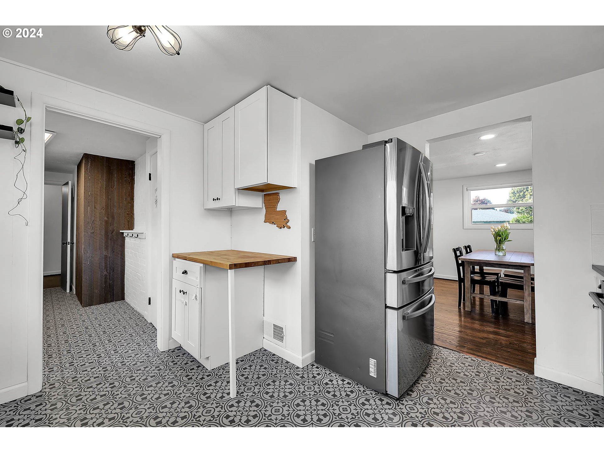 1617 Parnell Drive Eugene, OR 97404 - Photo 13 of 39 a kitchen with stainless steel appliances kitchen island granite countertop a refrigerator a stove and a sink with wooden floor