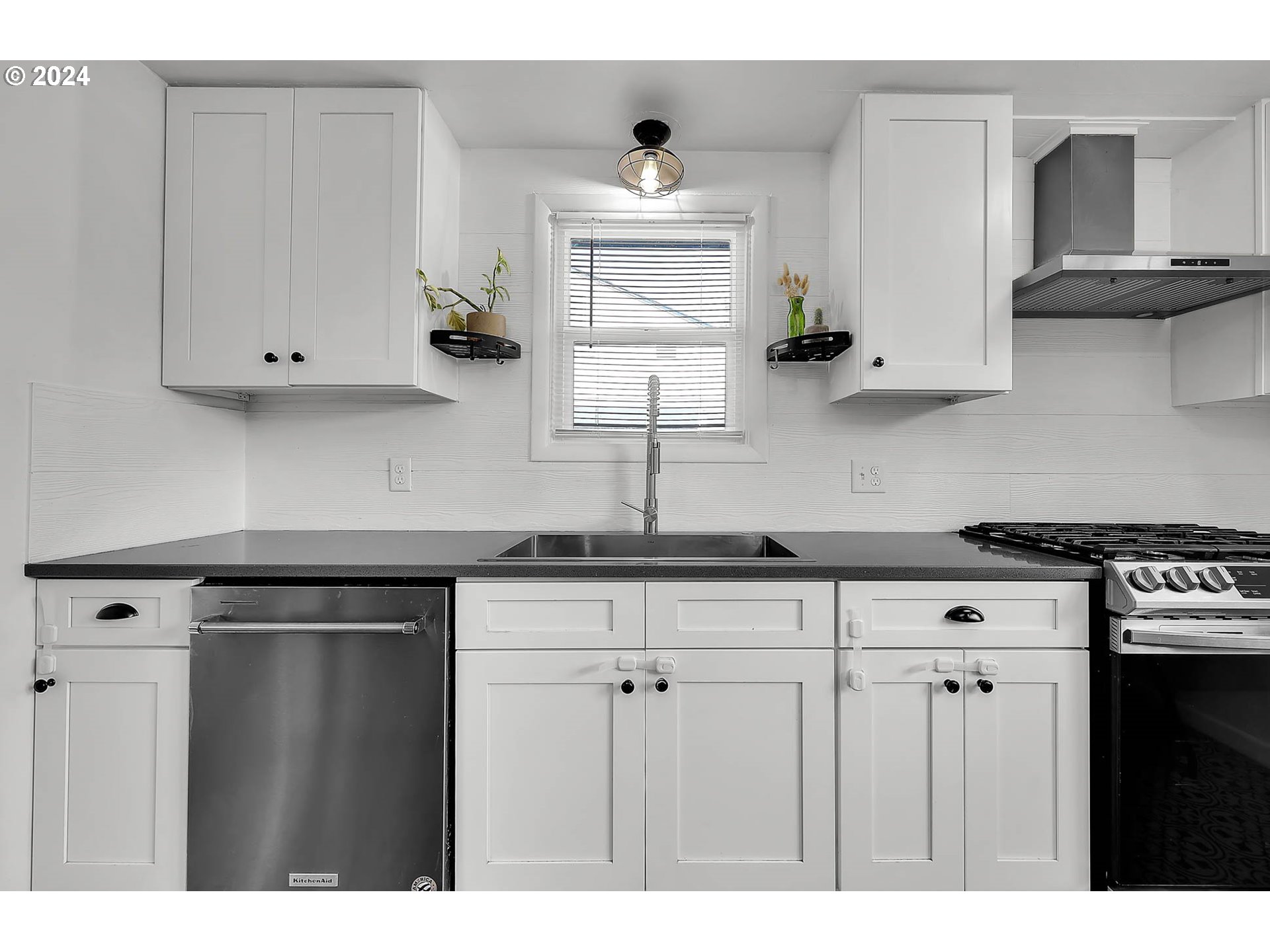 1617 Parnell Drive Eugene, OR 97404 - Photo 14 of 39 a kitchen with stainless steel appliances granite countertop a sink a stove and a granite counter tops