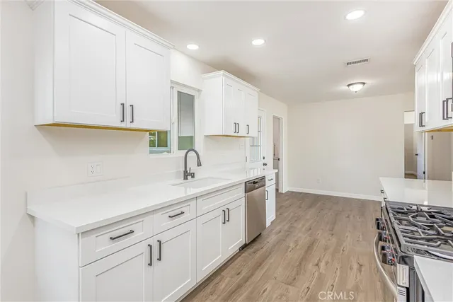a kitchen with a sink stove and cabinets