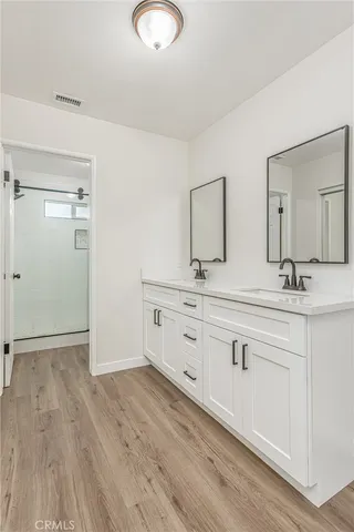 a bathroom with a shower and a sink