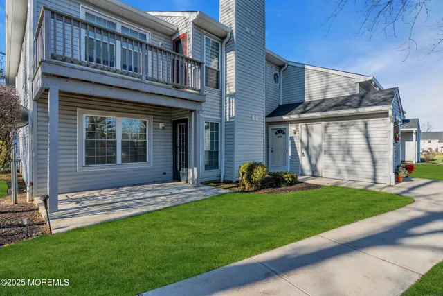 a view of a house with a yard and sitting area