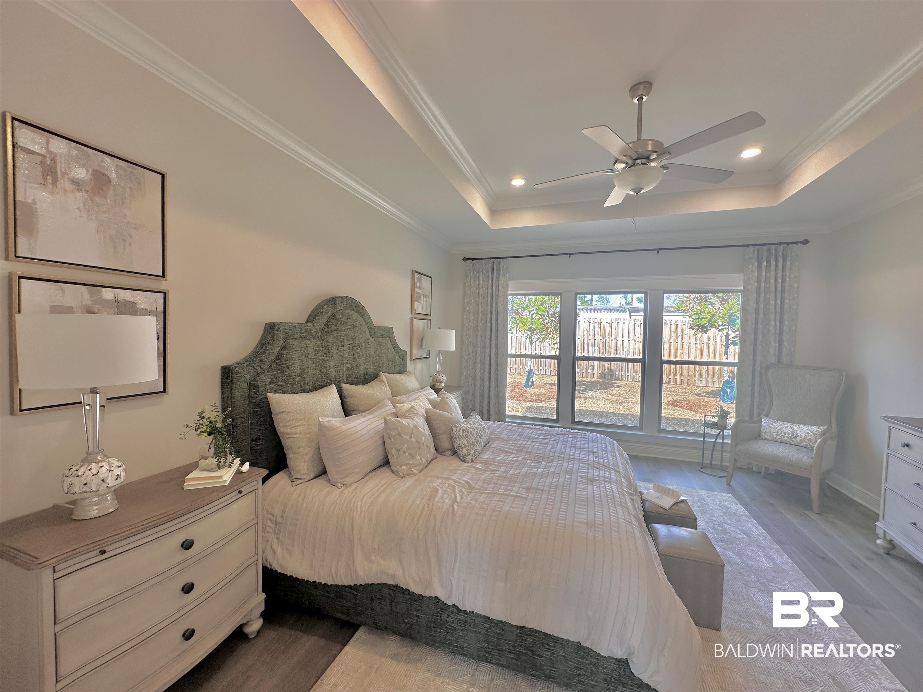 691 Kitfox Avenue Fairhope, AL 36532 - Photo 10 of 42 Bedroom featuring crown molding, wood-type flooring, and a tray ceiling
