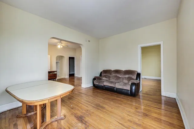 a kitchen with stainless steel appliances granite countertop a stove top oven a sink dishwasher and cabinets with wooden floor