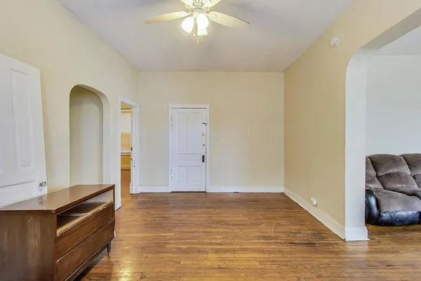 an empty room with wooden floor and closet