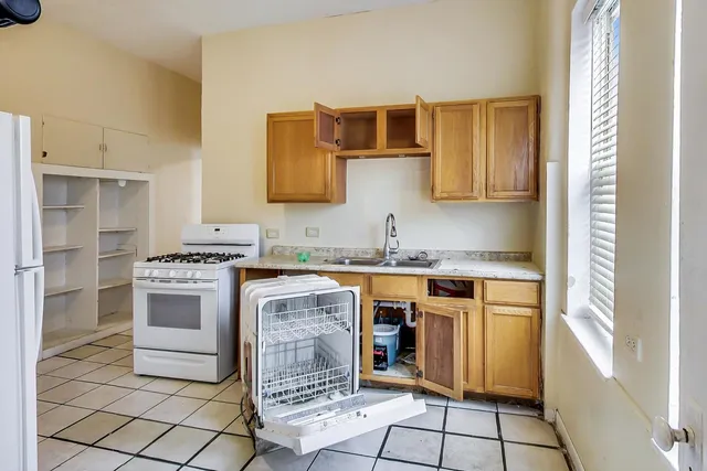 a kitchen with stainless steel appliances granite countertop a stove and a microwave