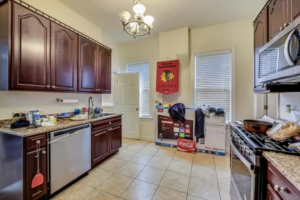 a kitchen with stainless steel appliances granite countertop a stove and a microwave
