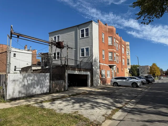 a kitchen with a refrigerator and a stove top oven