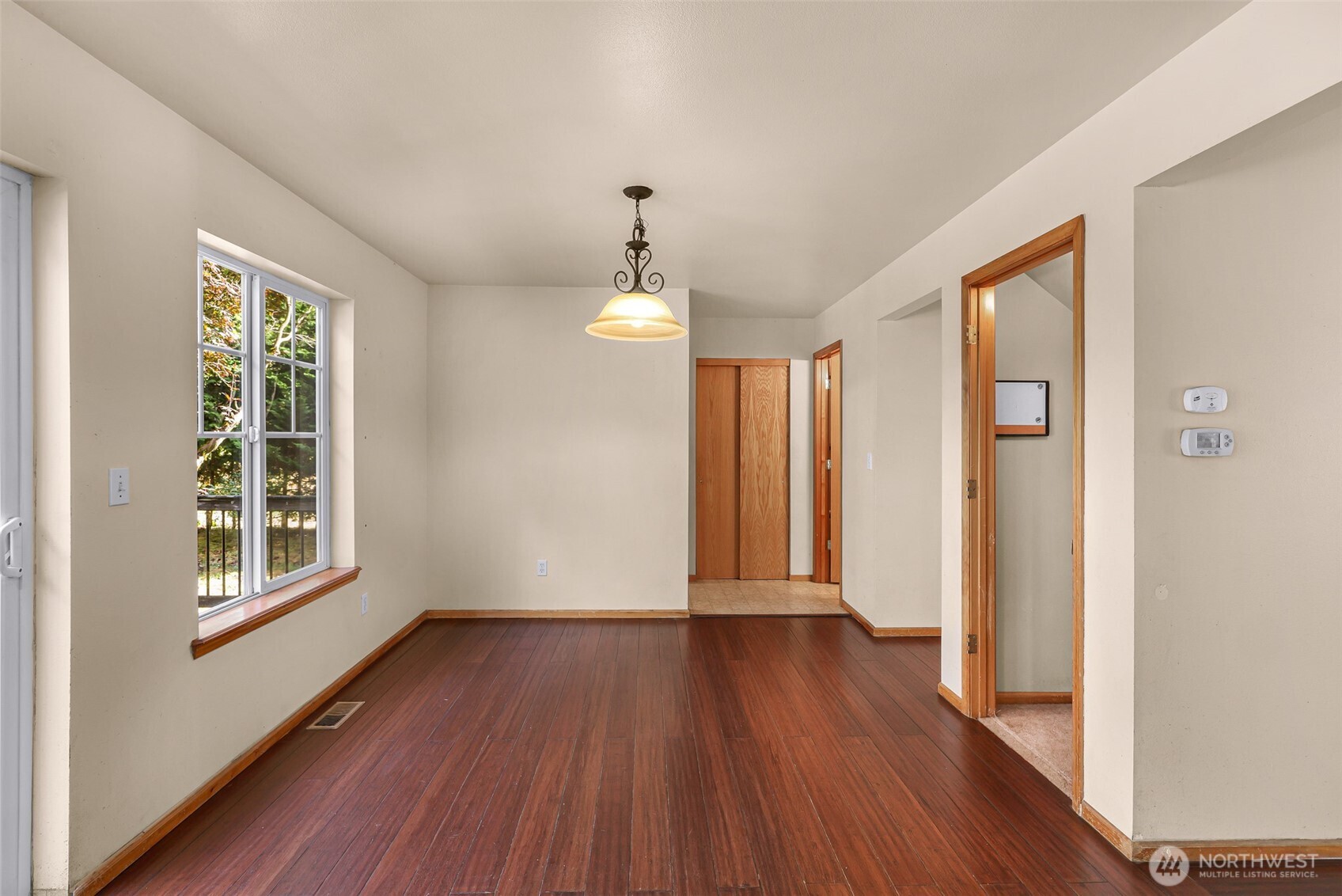 18002 Tualco Road Monroe, WA 98272 - Photo 13 of 39 an empty room with wooden floor and windows