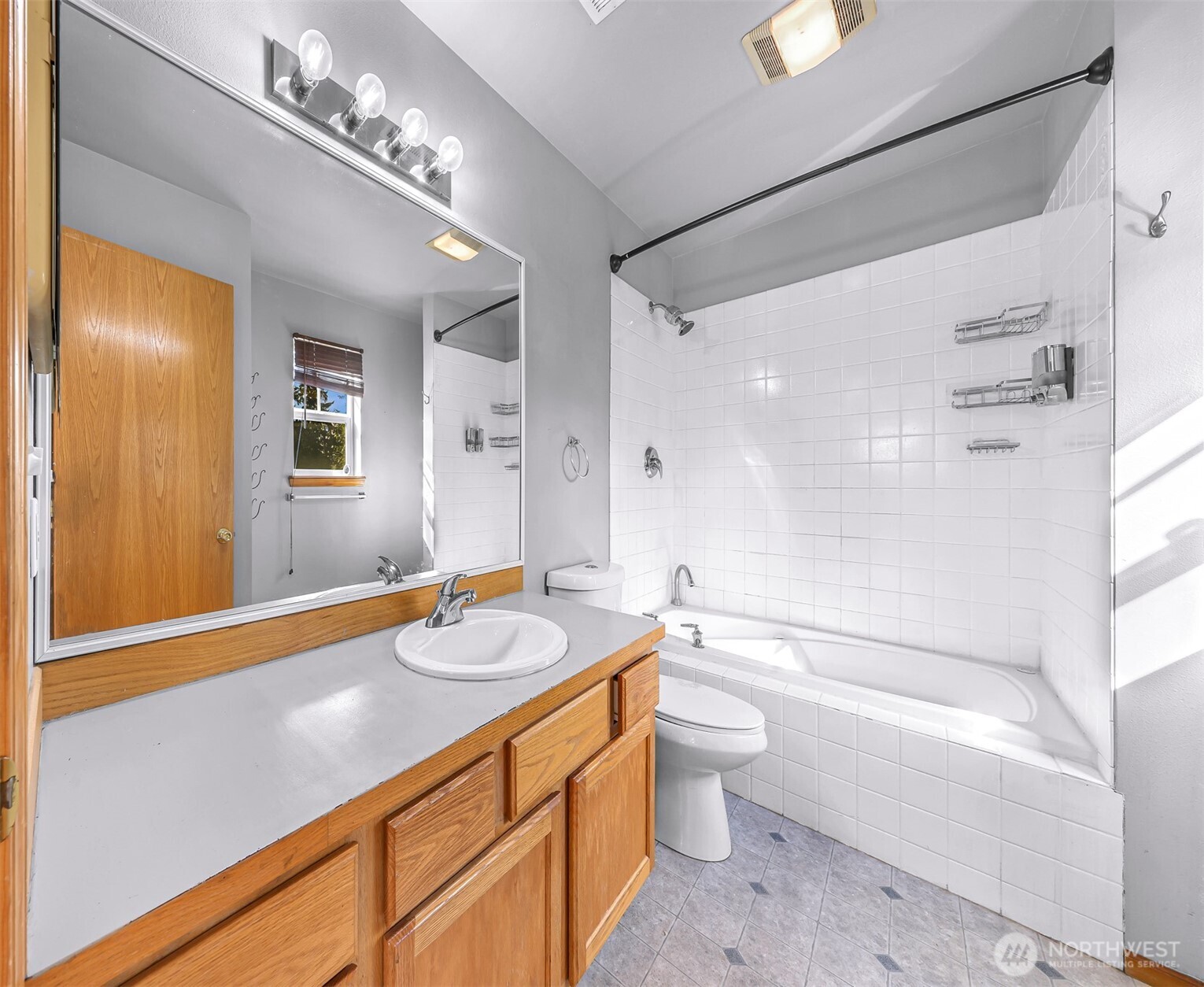 18002 Tualco Road Monroe, WA 98272 - Photo 21 of 39 a bathroom with a granite countertop sink a toilet a mirror and shower
