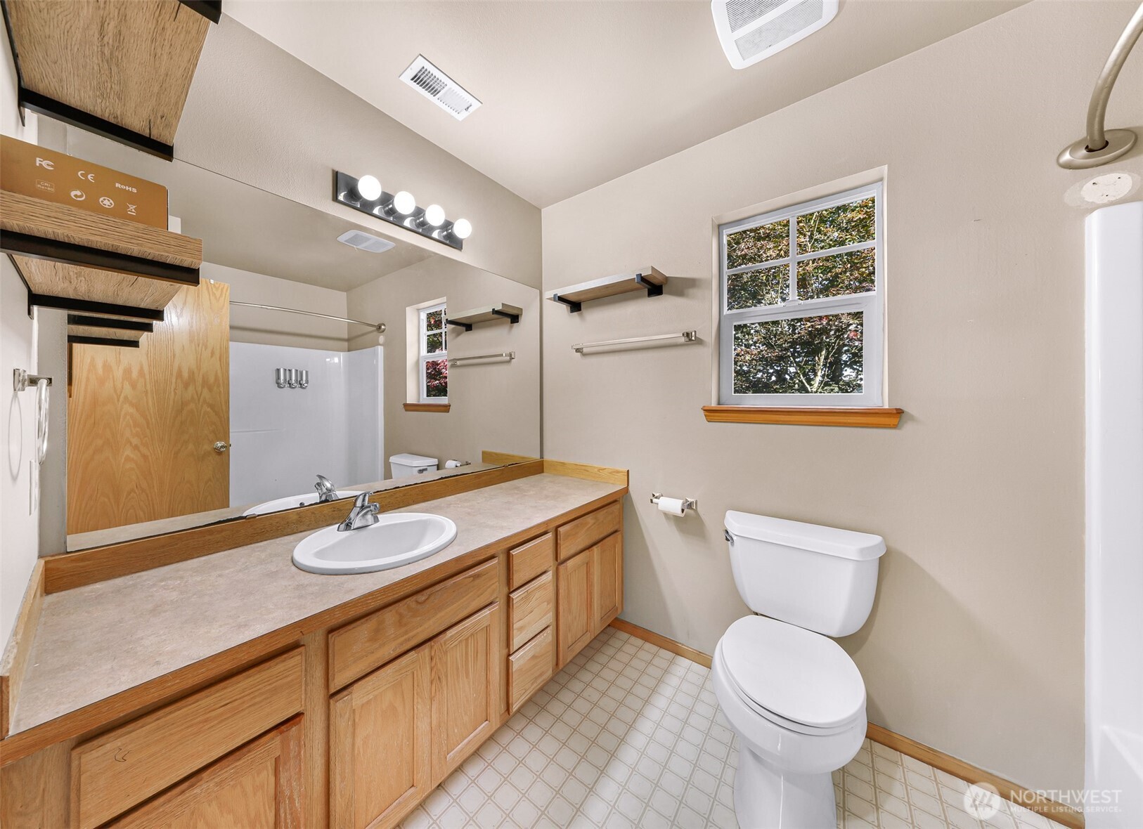 18002 Tualco Road Monroe, WA 98272 - Photo 27 of 39 a bathroom with a granite countertop toilet sink and mirror