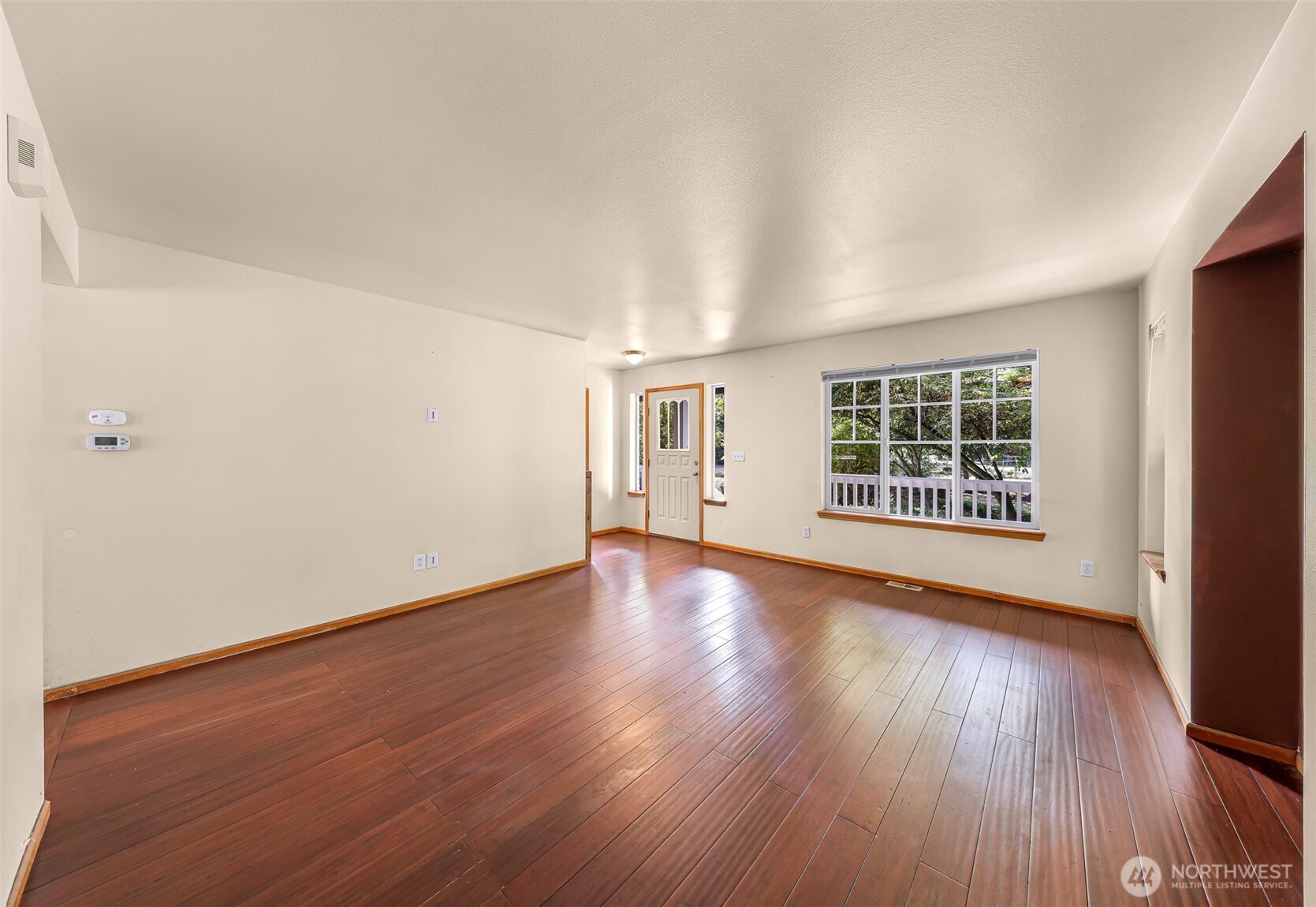 18002 Tualco Road Monroe, WA 98272 - Photo 4 of 39 an empty room with wooden floor and windows