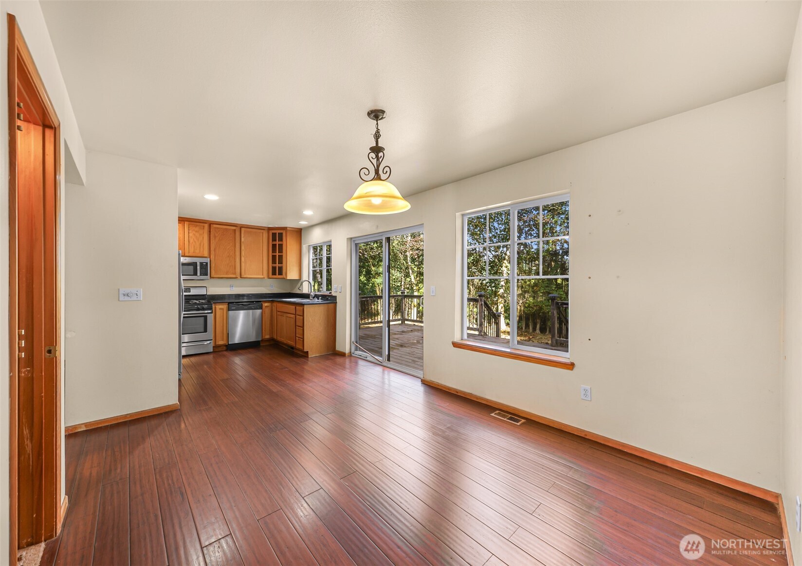 18002 Tualco Road Monroe, WA 98272 - Photo 10 of 39 an empty room with wooden floor chandelier and windows