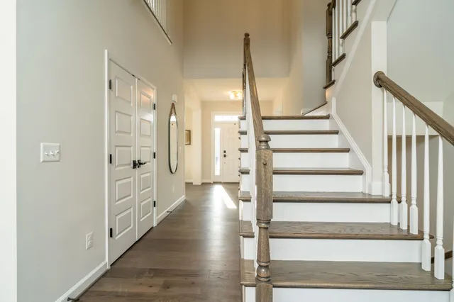 a view of an entryway with wooden floor and staircase