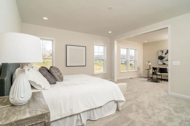 a spacious bedroom with a bed and a large mirror