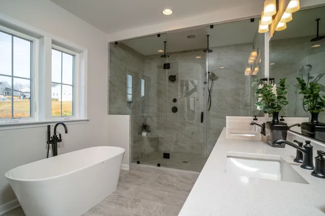 a white bath tub sitting in a bathroom and shower