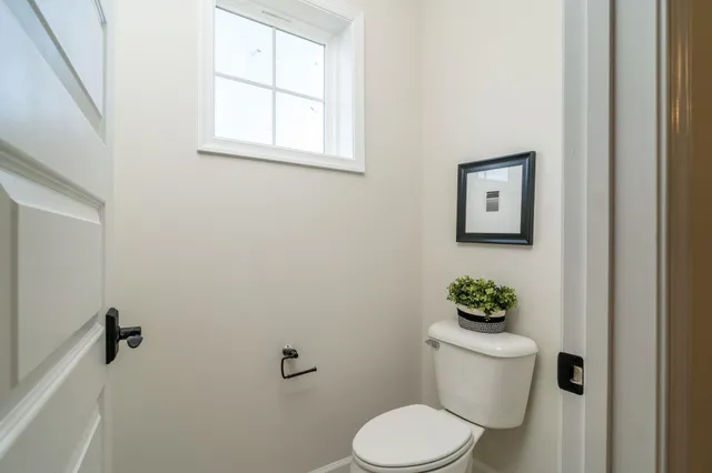 a white toilet sitting next to a bathroom sink