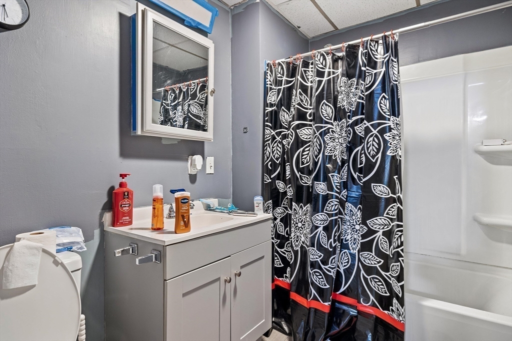 340 Harding Street Worcester, MA 01610 - Photo 14 of 42 a bathroom with a sink and a shower curtain