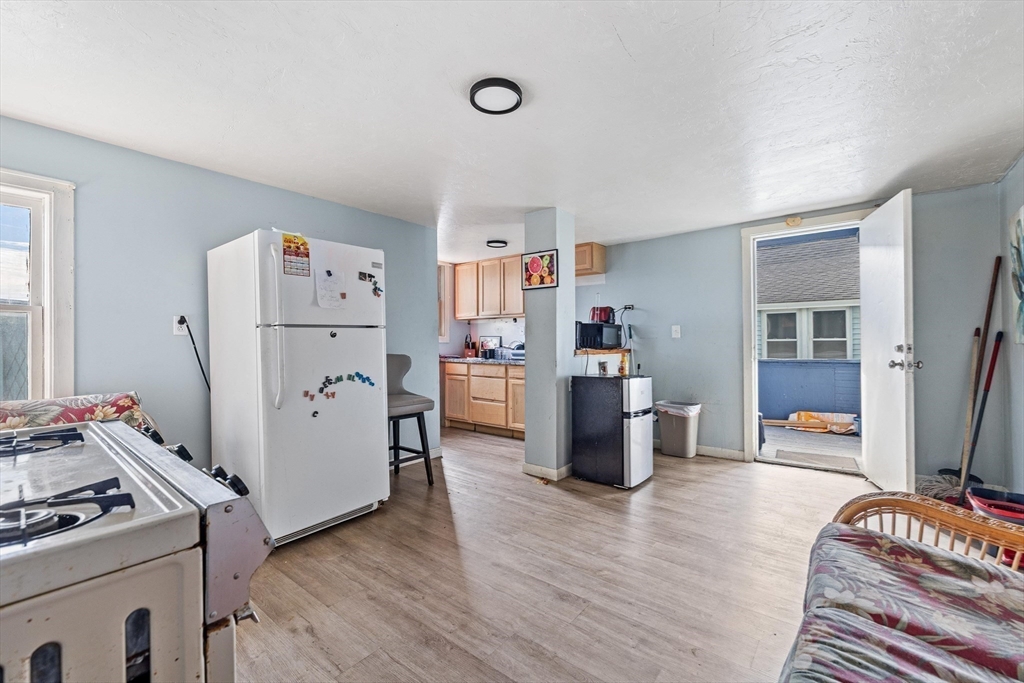 340 Harding Street Worcester, MA 01610 - Photo 17 of 42 a room with furniture and a refrigerator