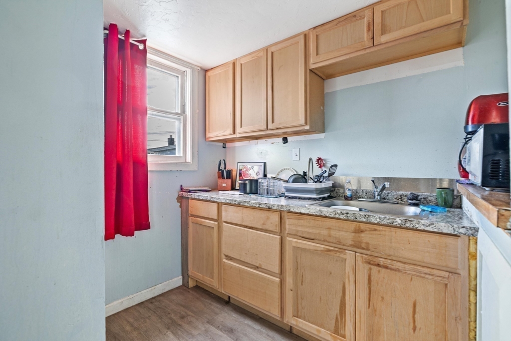 340 Harding Street Worcester, MA 01610 - Photo 20 of 42 a kitchen with stainless steel appliances granite countertop a sink a stove and cabinets