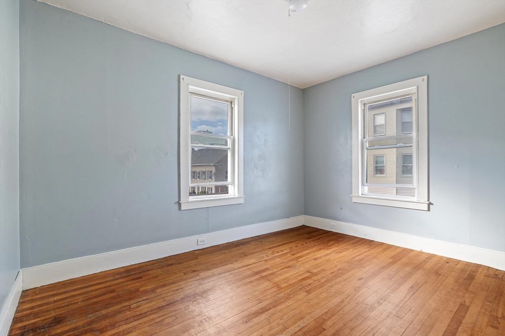 340 Harding Street Worcester, MA 01610 - Photo 23 of 42 a view of an empty room with wooden floor and a window