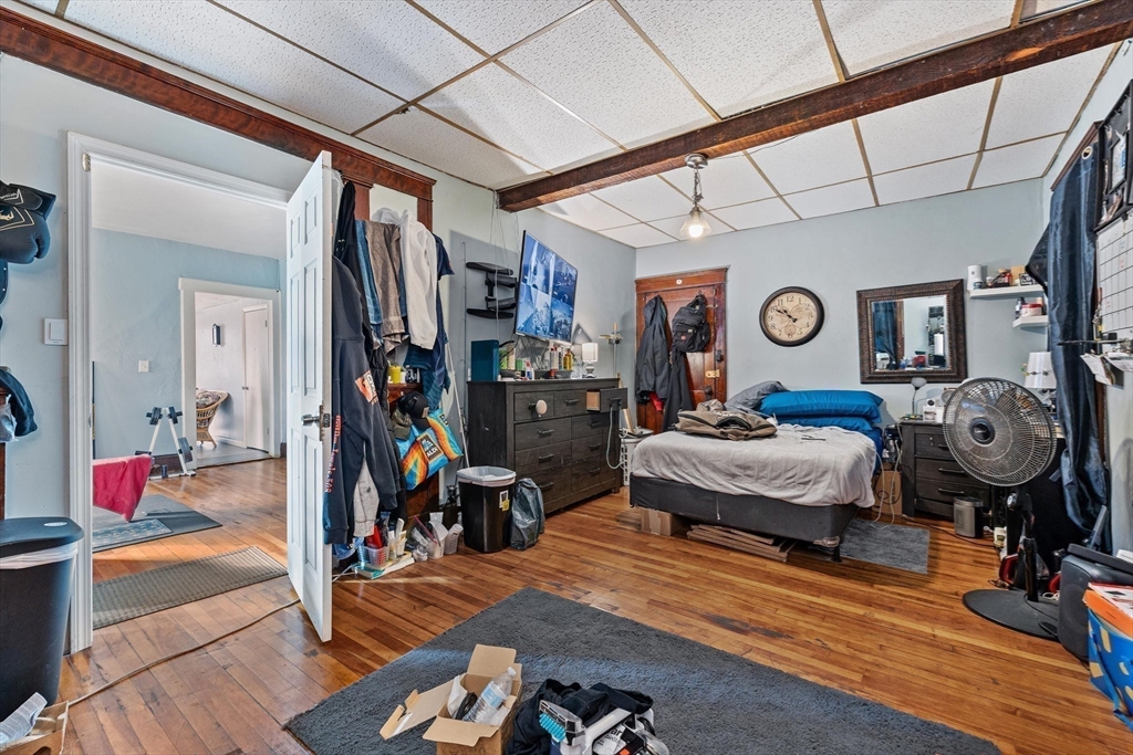 340 Harding Street Worcester, MA 01610 - Photo 24 of 42 a bedroom with a bed and wooden floor