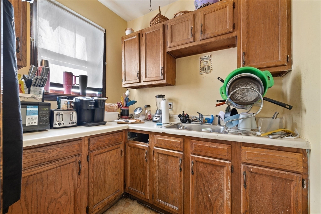 340 Harding Street Worcester, MA 01610 - Photo 28 of 42 a kitchen with cabinets and stainless steel appliances