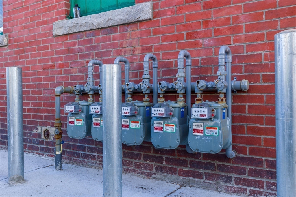 340 Harding Street Worcester, MA 01610 - Photo 39 of 42 a brick building with a bench and a potted plant