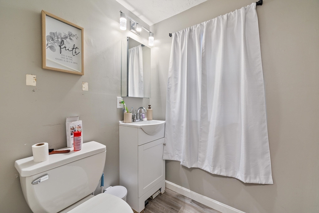 340 Harding Street Worcester, MA 01610 - Photo 10 of 42 a bathroom with a toilet sink vanity and tub
