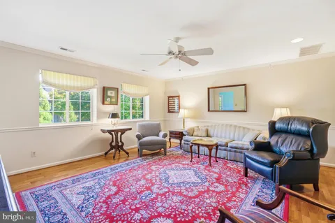 a living room with furniture a rug and a table