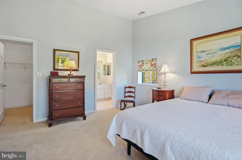 a bedroom with a bed and dresser