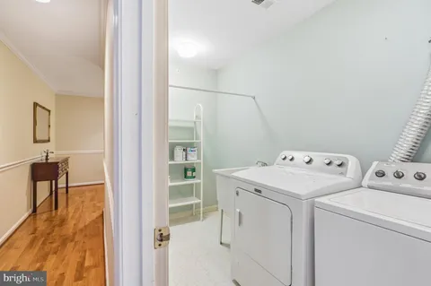a view of washer and dryer with kitchen in the background