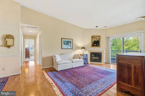 a living room with fireplace furniture and a table
