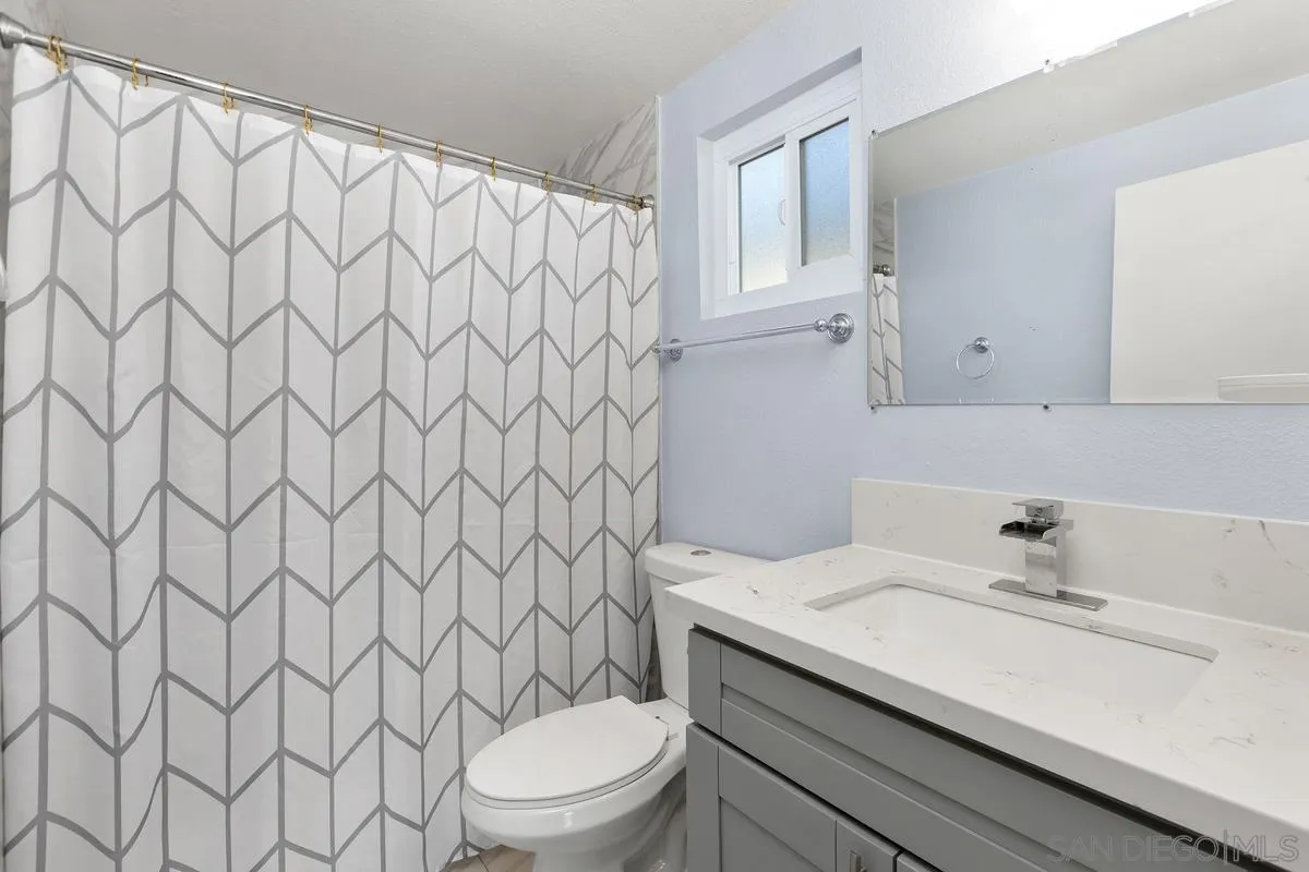 9956 Via Debbie Santee, CA 92071 - Photo 19 of 30 a bathroom with a granite countertop sink and a toilet