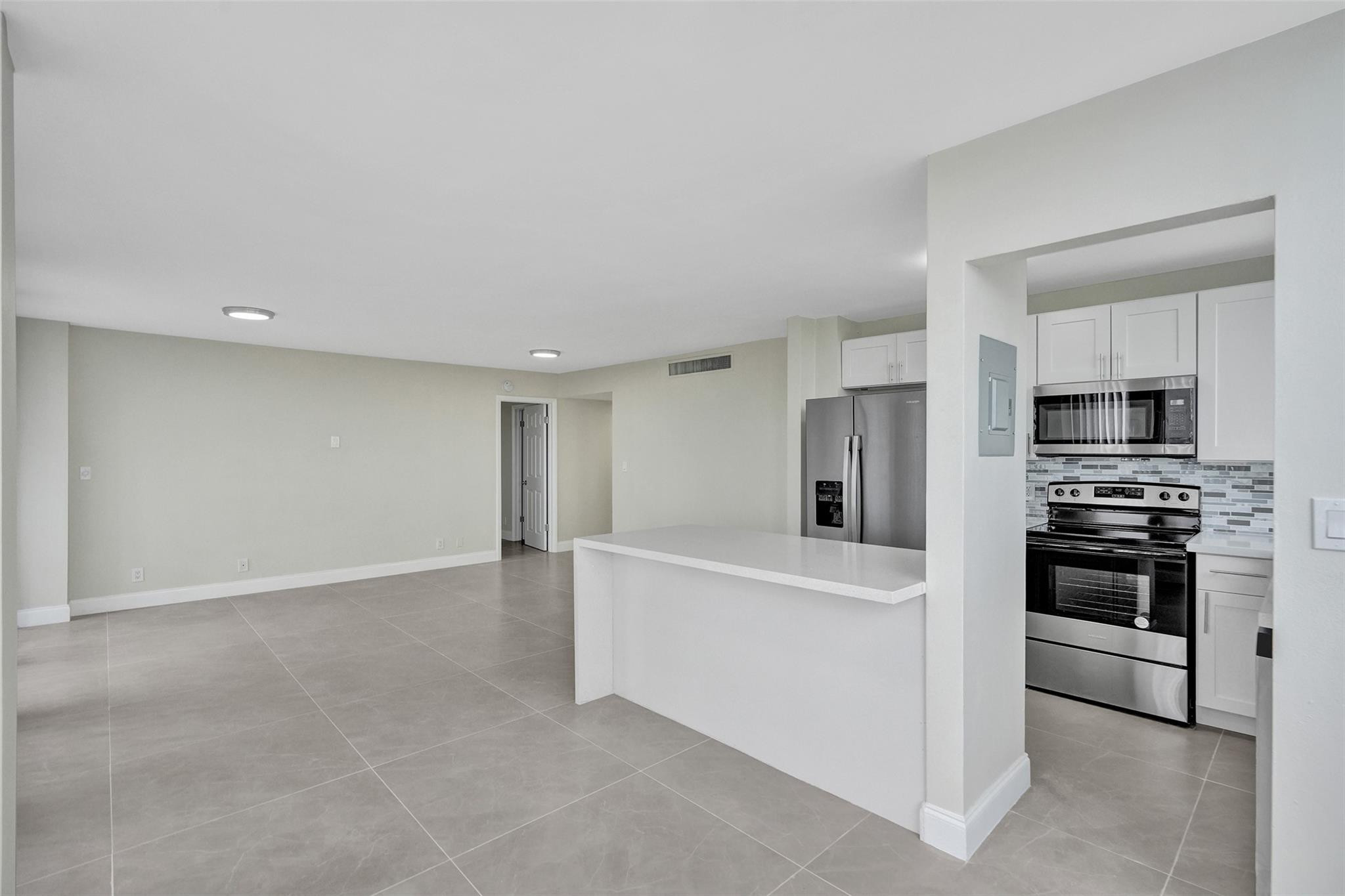 4222 Inverrary Boulevard, Unit 4810 Lauderhill, FL 33319 - Photo 3 of 63 a view of a kitchen with refrigerator stove and kitchen