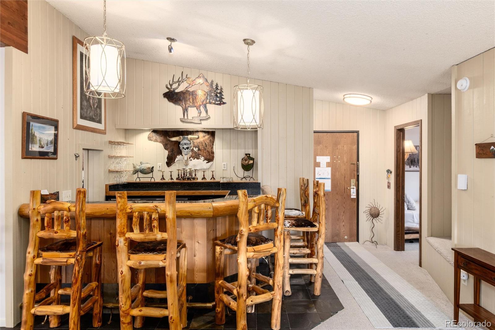 490 Kings Crossing Road, Unit 631633 Winter Park, CO 80482 - Photo 13 of 43 a room with stainless steel appliances kitchen island granite countertop furniture and a wooden floor