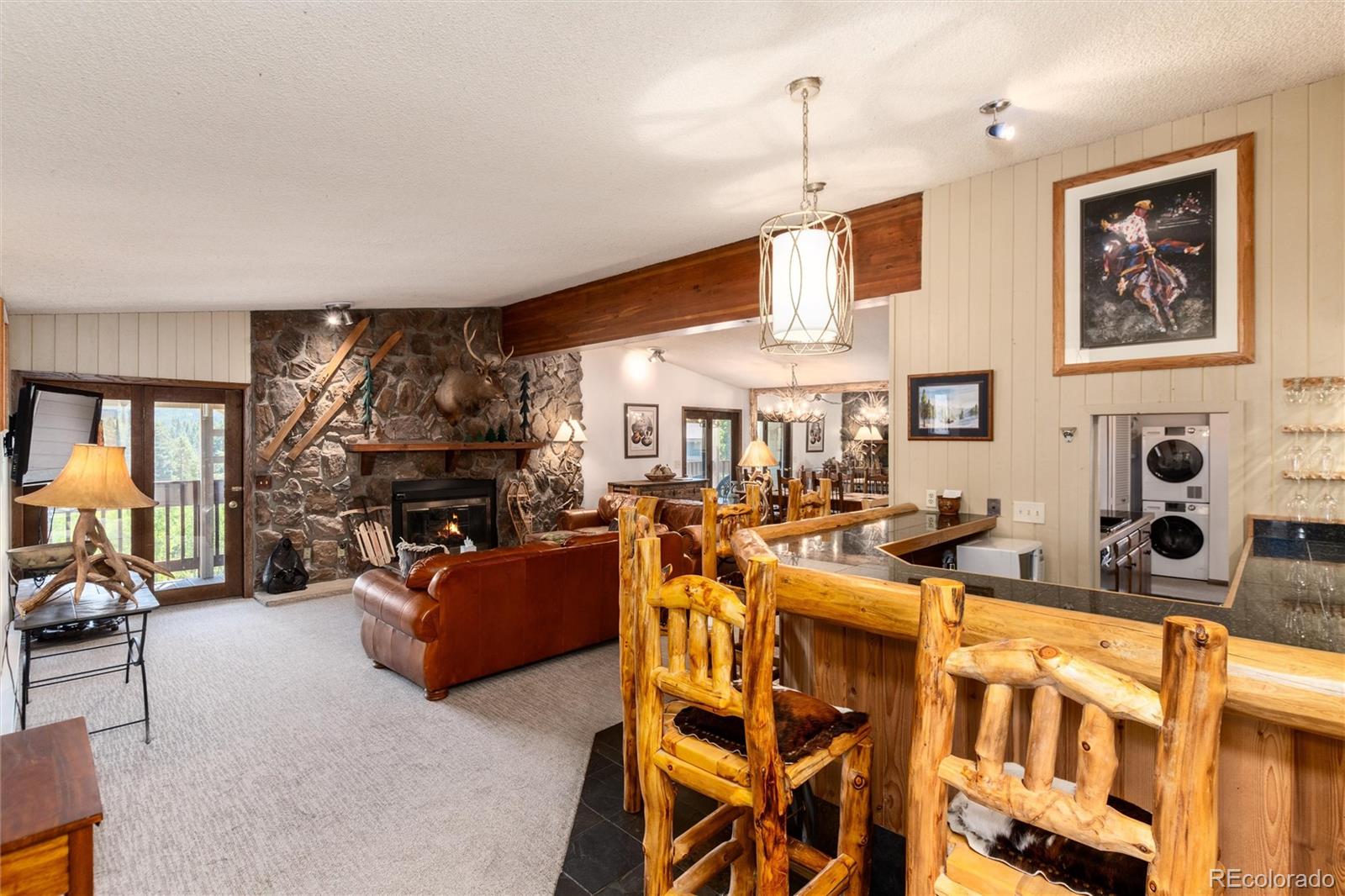 490 Kings Crossing Road, Unit 631633 Winter Park, CO 80482 - Photo 14 of 43 a living room with furniture a fireplace and a flat screen tv