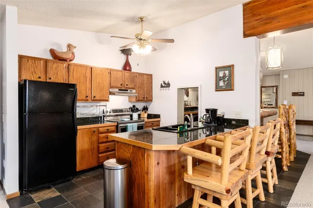 a kitchen with a refrigerator stove and sink