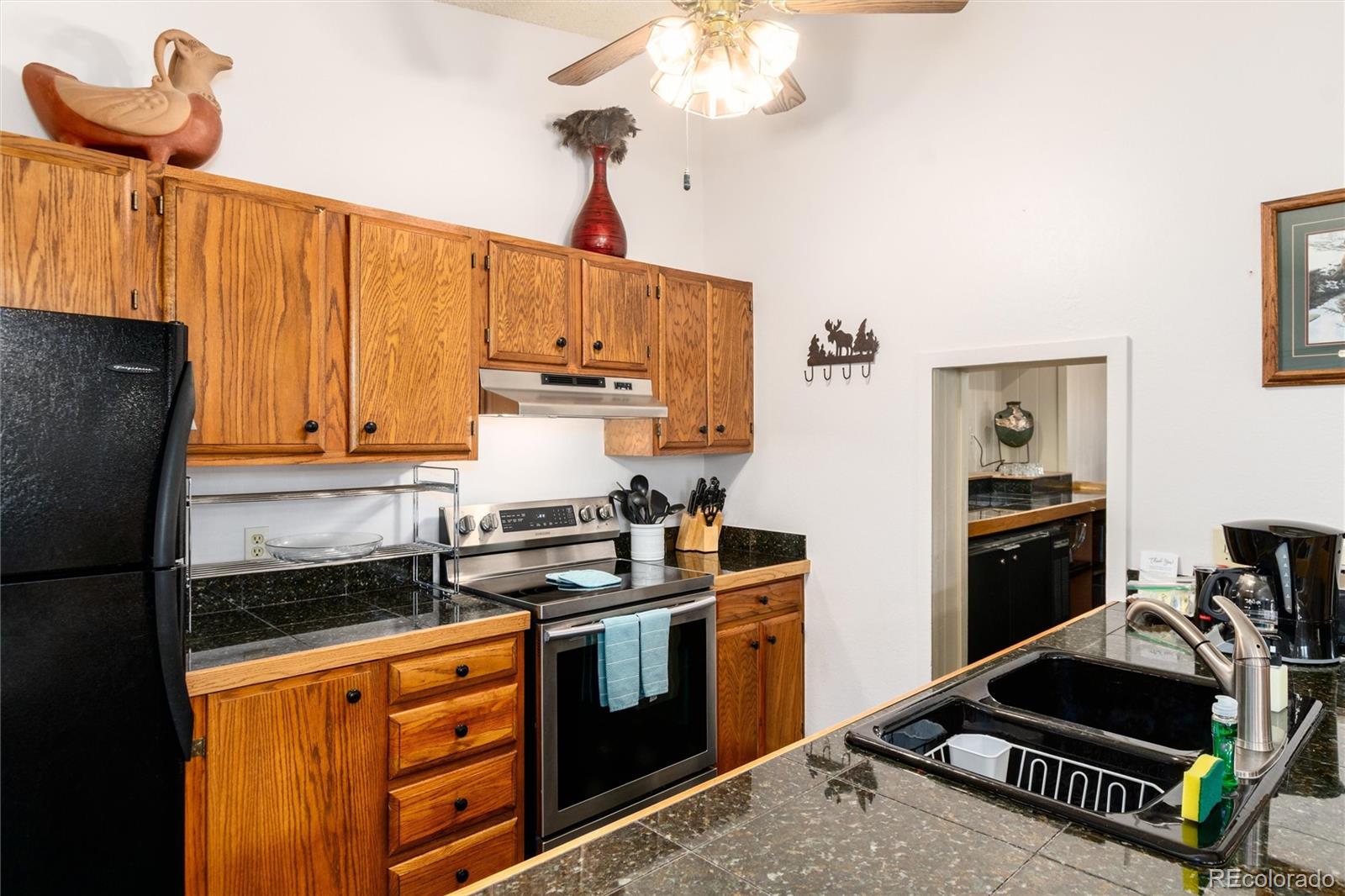 490 Kings Crossing Road, Unit 631633 Winter Park, CO 80482 - Photo 20 of 43 a kitchen with stainless steel appliances granite countertop a stove and a refrigerator