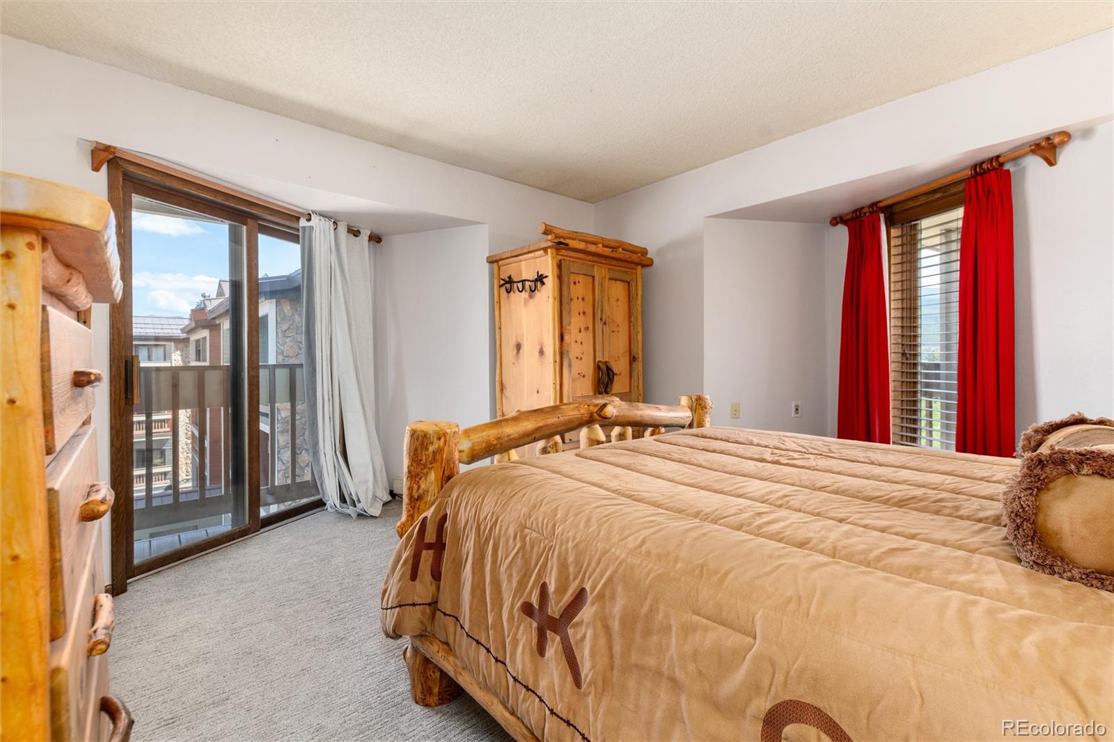 490 Kings Crossing Road, Unit 631633 Winter Park, CO 80482 - Photo 26 of 43 a bedroom with a bed and large windows