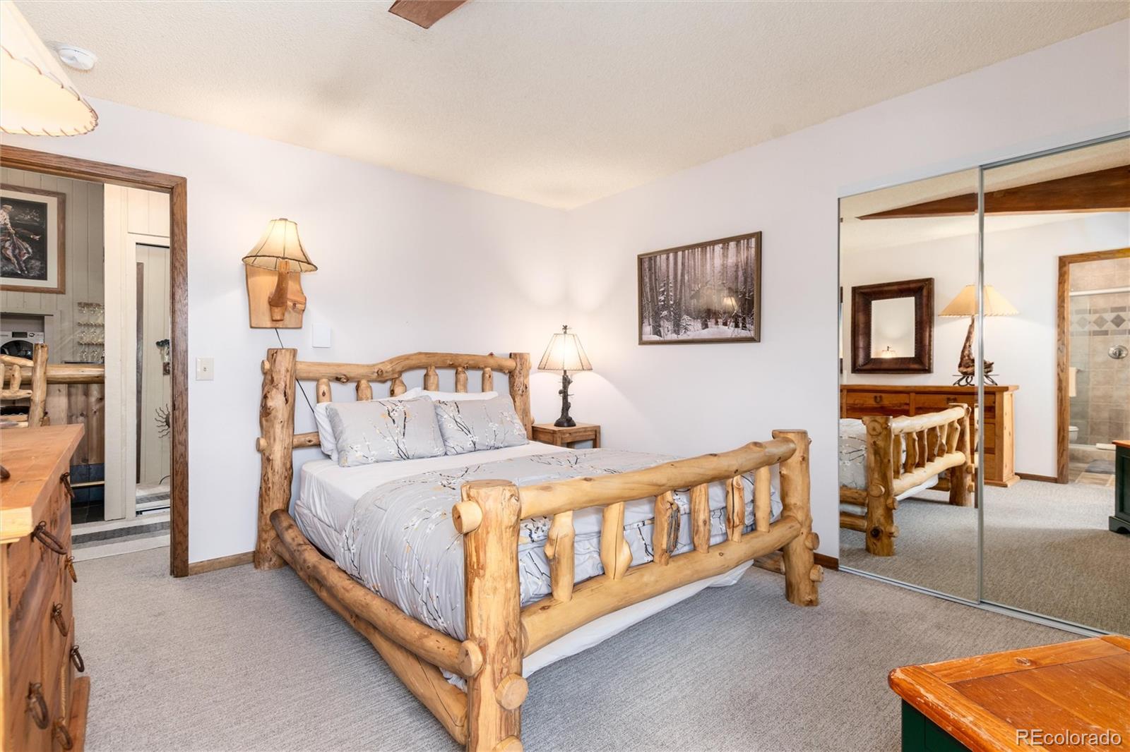 490 Kings Crossing Road, Unit 631633 Winter Park, CO 80482 - Photo 30 of 43 a bedroom with a bed and a lamp on table