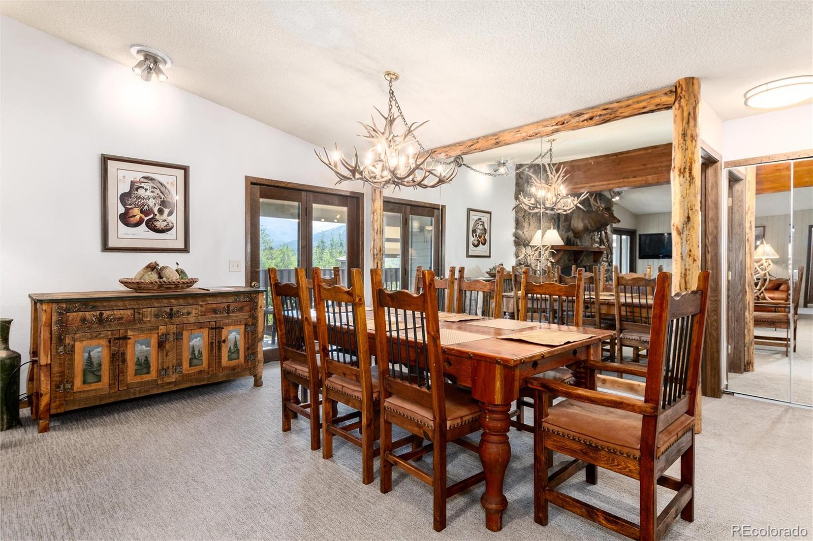 490 Kings Crossing Road, Unit 631633 Winter Park, CO 80482 - Photo 9 of 43 a view of a dining room with furniture and chandelier